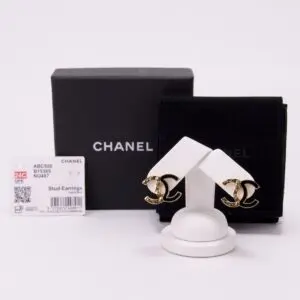 Chanel gold stud earrings with packaging.