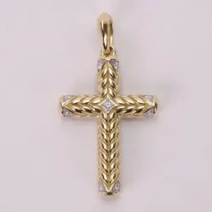 Gold cross pendant with intricate detailing.