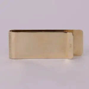 Gold metal money clip, plain design.