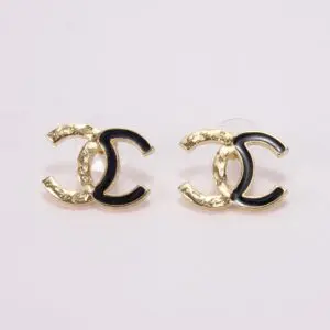 Gold and black logo earrings on display.