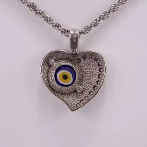 Heart-shaped pendant with evil eye design.