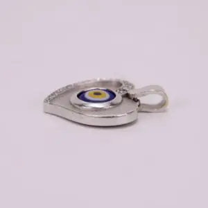 Heart-shaped silver pendant with evil eye.