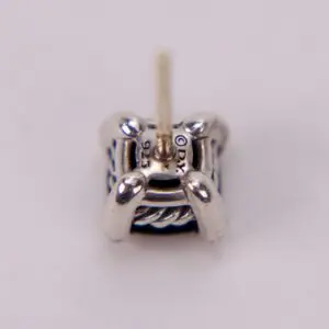 Close-up of a silver earring stud.