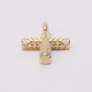 Gold cross pendant with intricate design.