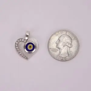 Heart-shaped pendant beside a quarter coin.