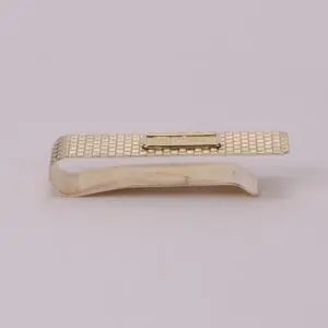 Gold textured money clip on white background.
