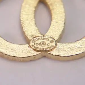 Gold Chanel logo close-up with label.