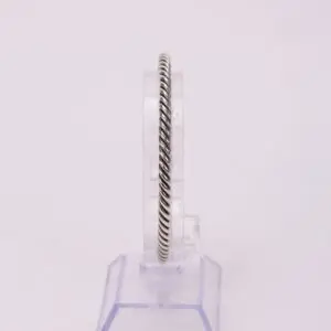 Silver twisted rope design bracelet on stand.