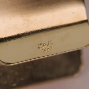 Gold jewelry with "L&M 14KT" engraving.