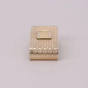 Gold textured rectangular lighter on display.