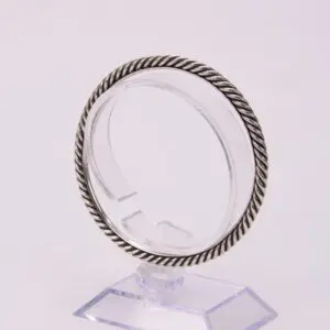 Silver twisted rope bangle on display stand.