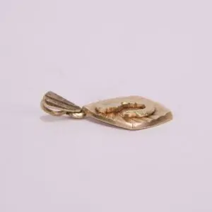 Gold pendant with embossed design.