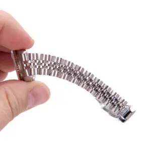 Hand holding a flexible metal watch bracelet.