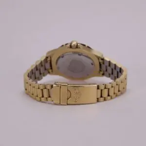 Gold wristwatch with metal link bracelet.