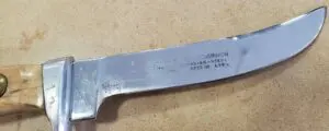 Knife with wooden handle on table surface.