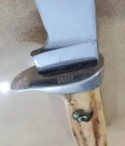 Knife blade with engraved serial number.