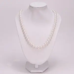 White pearl necklace on display stand.