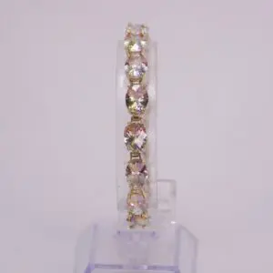 Gold bracelet with sparkling gemstones on display.