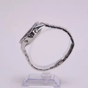 Silver wristwatch displayed on a plastic stand.