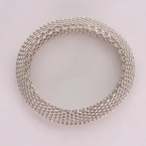 Silver woven chain bracelet on display.