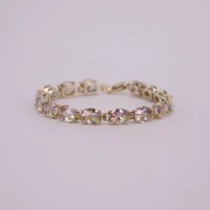 Gold bracelet with multicolored gemstones.