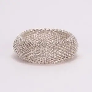 Silver mesh ring on plain background.