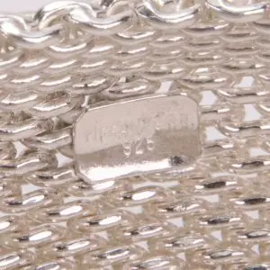 Silver mesh bracelet with engraved label.