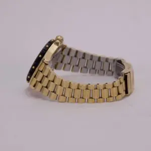 Gold and silver watch with metal band.