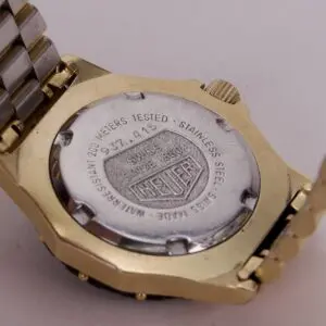 Back of a gold and silver wristwatch.