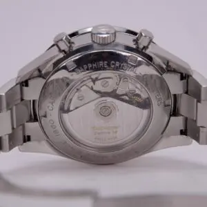 Silver watch with transparent back view.