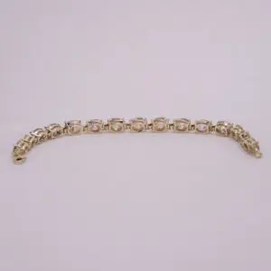 Gold bracelet with clear gemstone accents.
