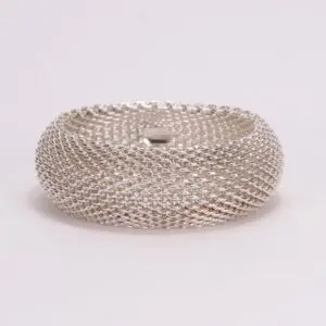Silver mesh bracelet on white background.