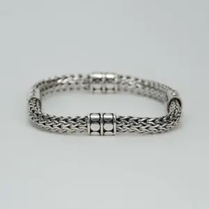 Silver woven bracelet with clasp details.