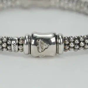 Silver beaded bracelet with intricate clasp.