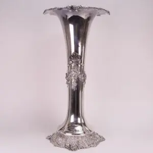 Ornate silver vase with floral details.