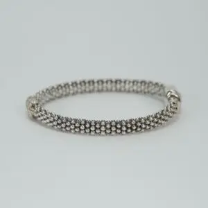 Silver beaded bracelet on plain background.
