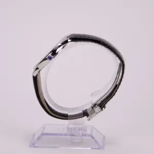 Side view of luxury wristwatch on stand.