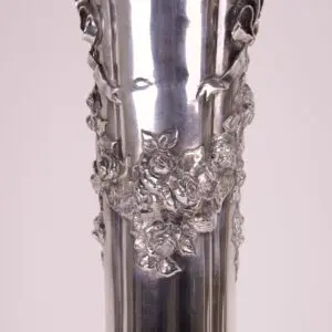 Silver vase with intricate floral design.