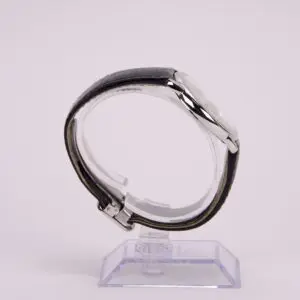 Side view of a wristwatch on stand.