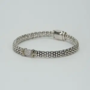 Silver beaded bracelet with decorative clasp.