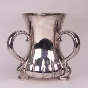 Silver vase with ornate curved handles.