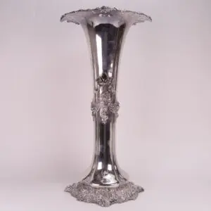 Ornate silver vase with elaborate floral design.