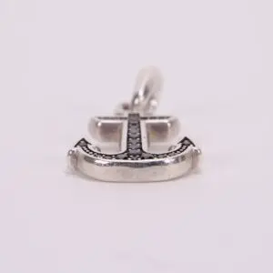 Anchor-shaped pendant with black gemstone accents.