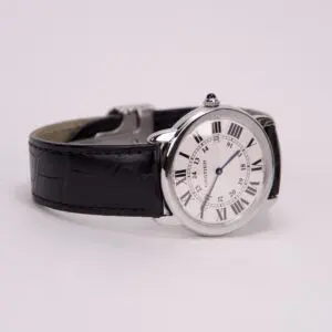 Silver watch with black leather strap.