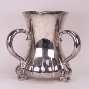 Silver decorative vase with ornate handles.