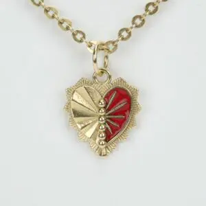 Gold heart pendant with red enamel design.