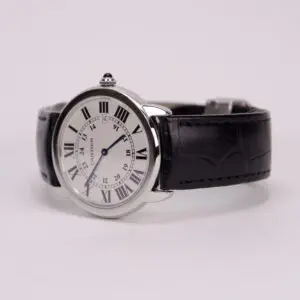 Silver watch with black leather strap.