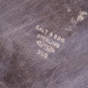 Engraving on scratched metal surface.