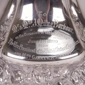 Engraved silver item with intricate detailing.