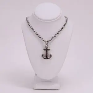 Anchor pendant necklace on display stand.